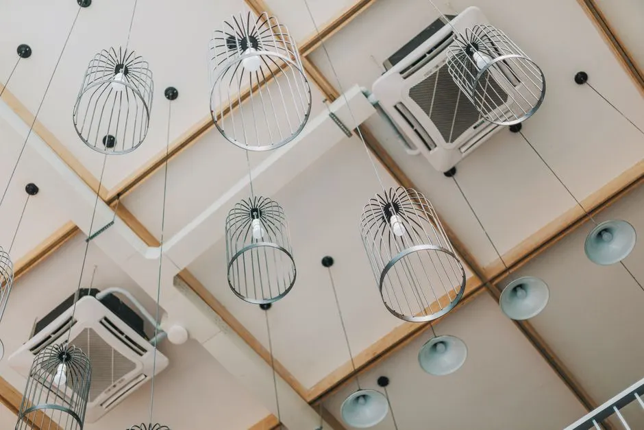 Low angle view of modern pendant lamps in a contemporary interior with a uniquely designed ceiling.